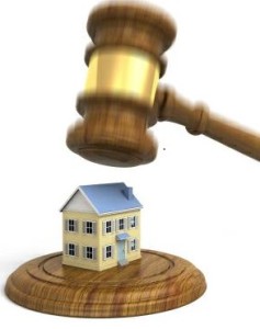 A gavel coming down on a house. Very high resolution 3D render.