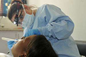 LILONGWE, Malawi - Master Sgt. Teresa J. Morgan, dental non-commissioned officer in charge of MEDREACH 11 of the 908th Aeromedical Staging Squadron, from Ariton, Ala. performs a dental procedure on a Malawian patient at the Partners in Hope Medical Centre.